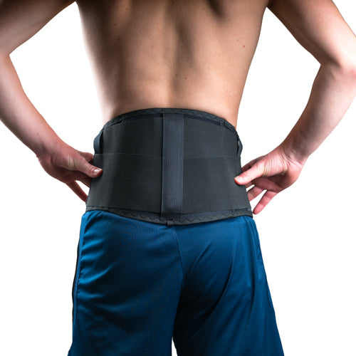 back view of the black FORMFIT BACK SUPPORT back support with wide support belt, person supports hands on hips.